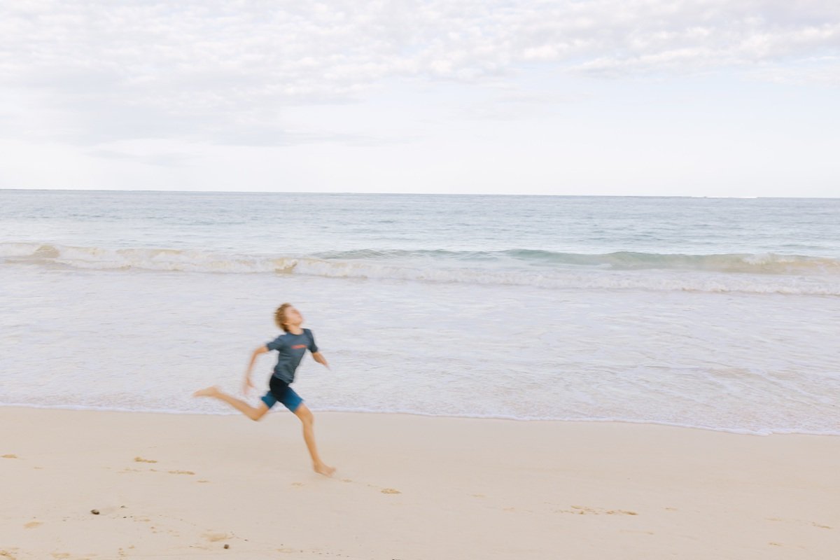 boy running along the beach