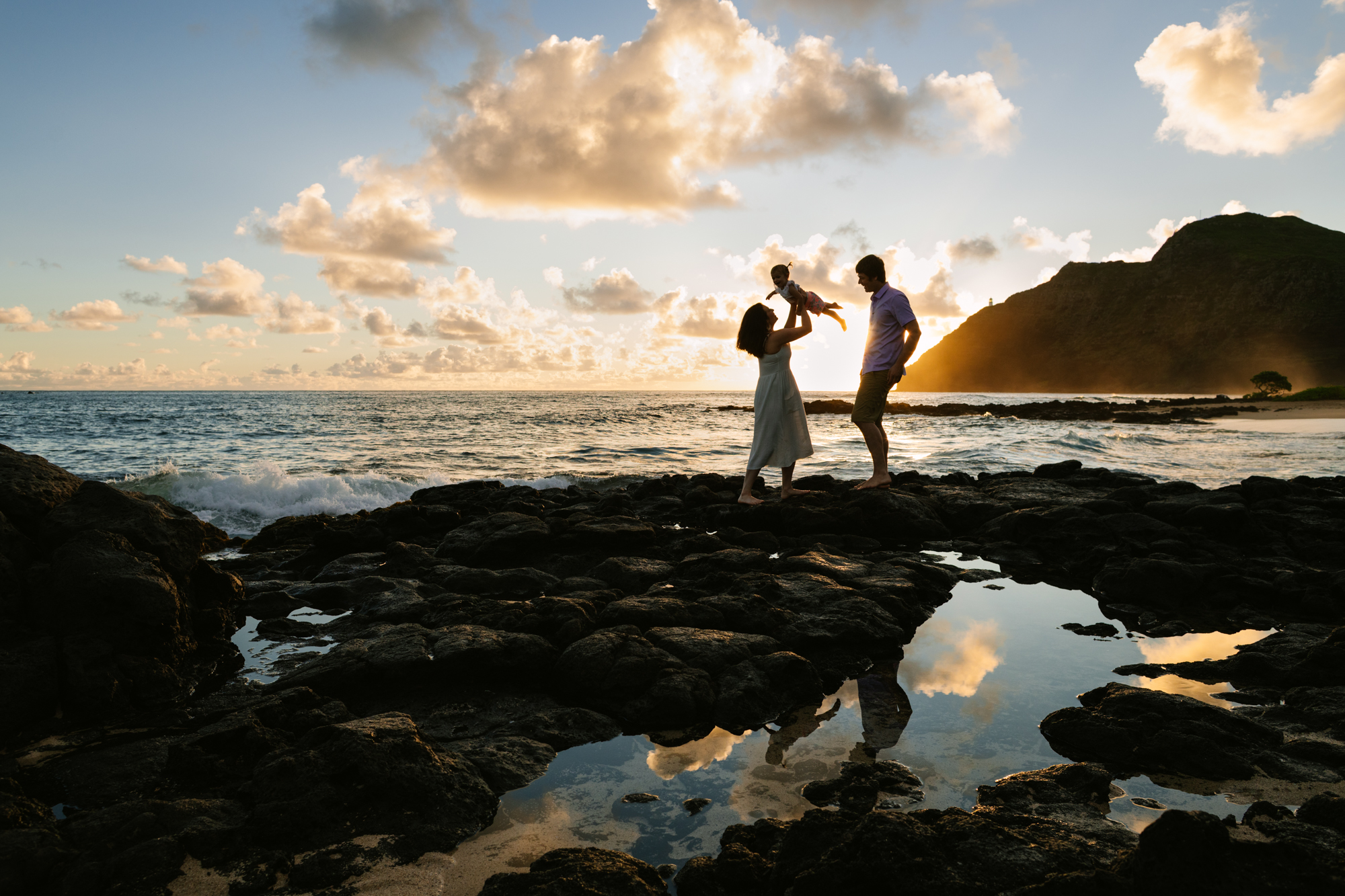 family silhouette at sunrise at baby makapuu tidepools