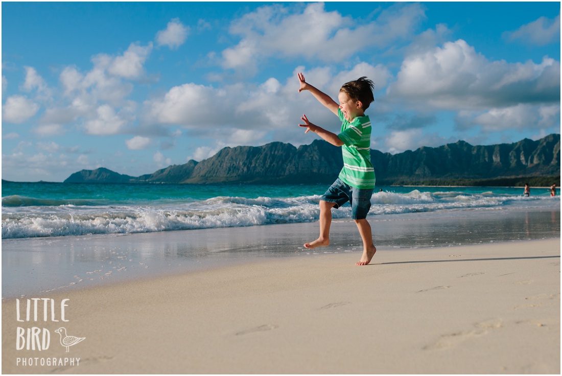 boy skipping at the beach in hawaii