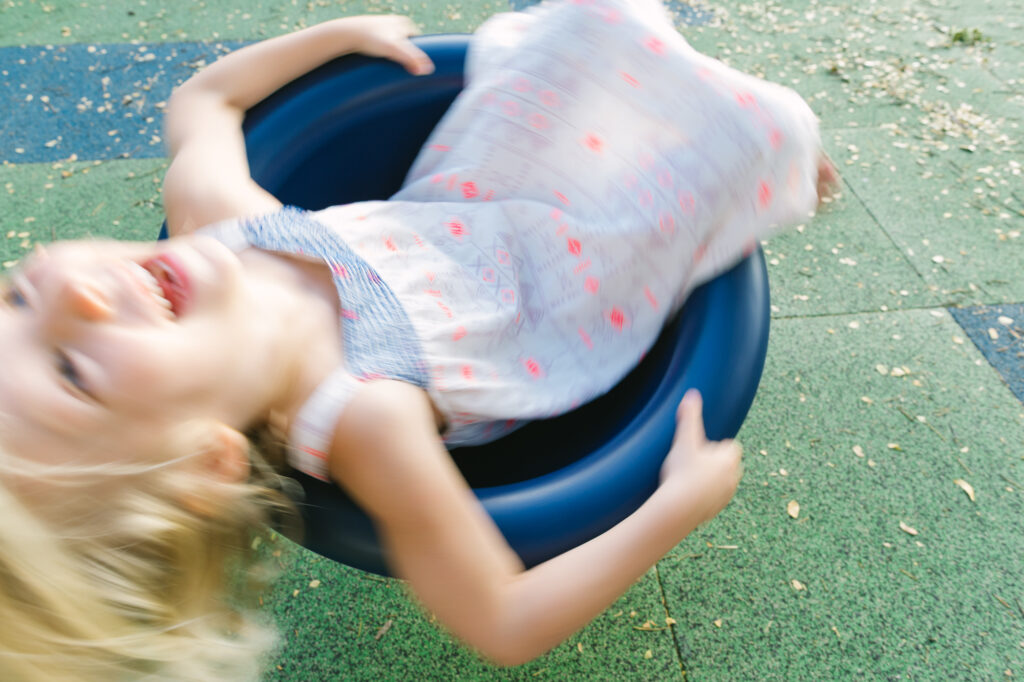 girl spinning at one of oahu's playgrounds at nuuanu valley park
