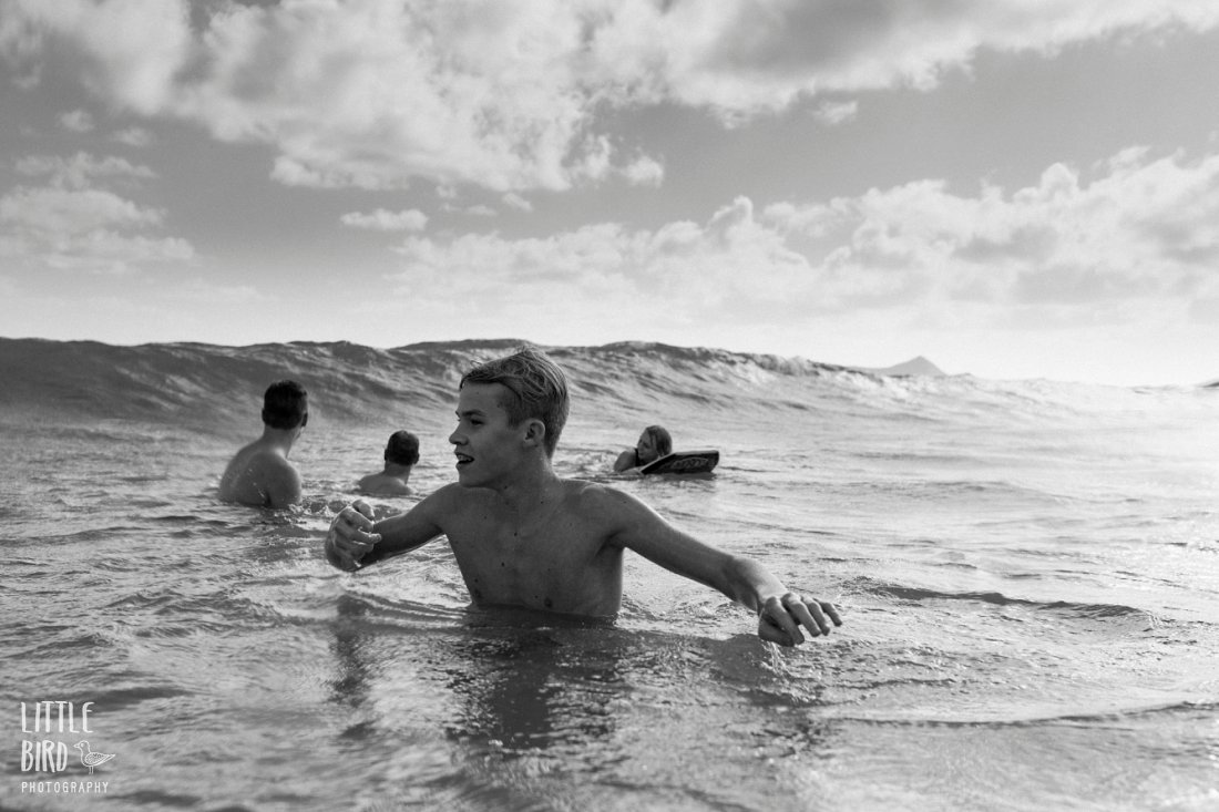 family bodyboarding during a photo session by waimanalo photographer