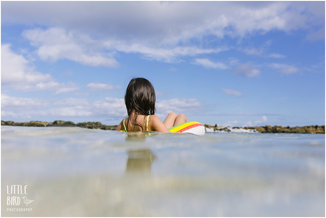 girl in an intertube floating in koolina lagoon