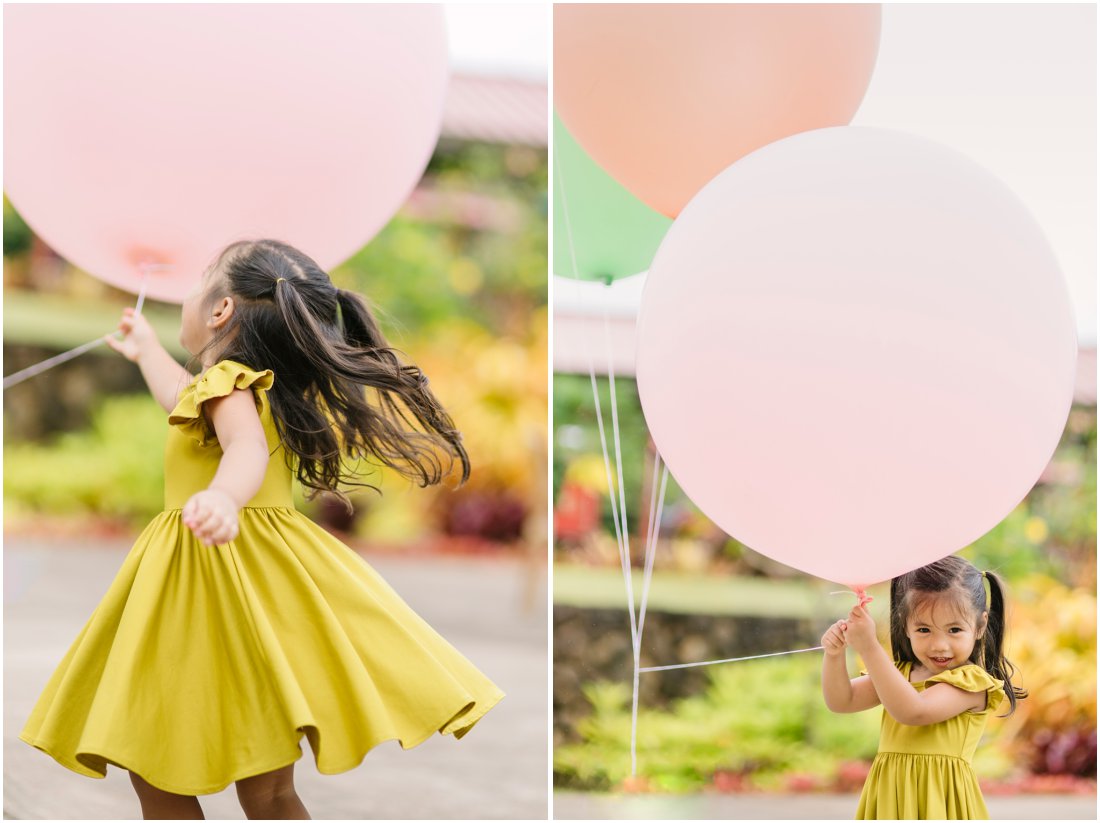 little girl with giant baloons