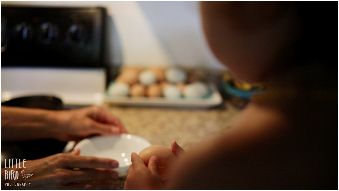 toddler helping mom make eggs