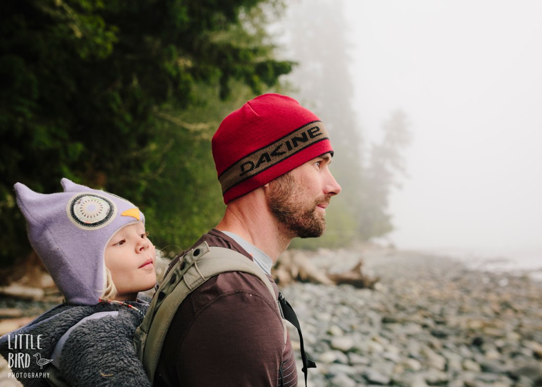 dad and daughter hiking in the fog of vancouver island