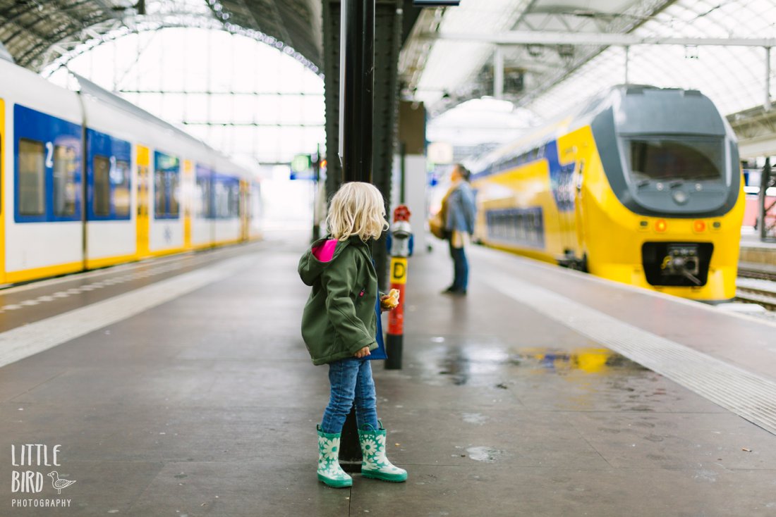 little girl at a train station in amsterdam