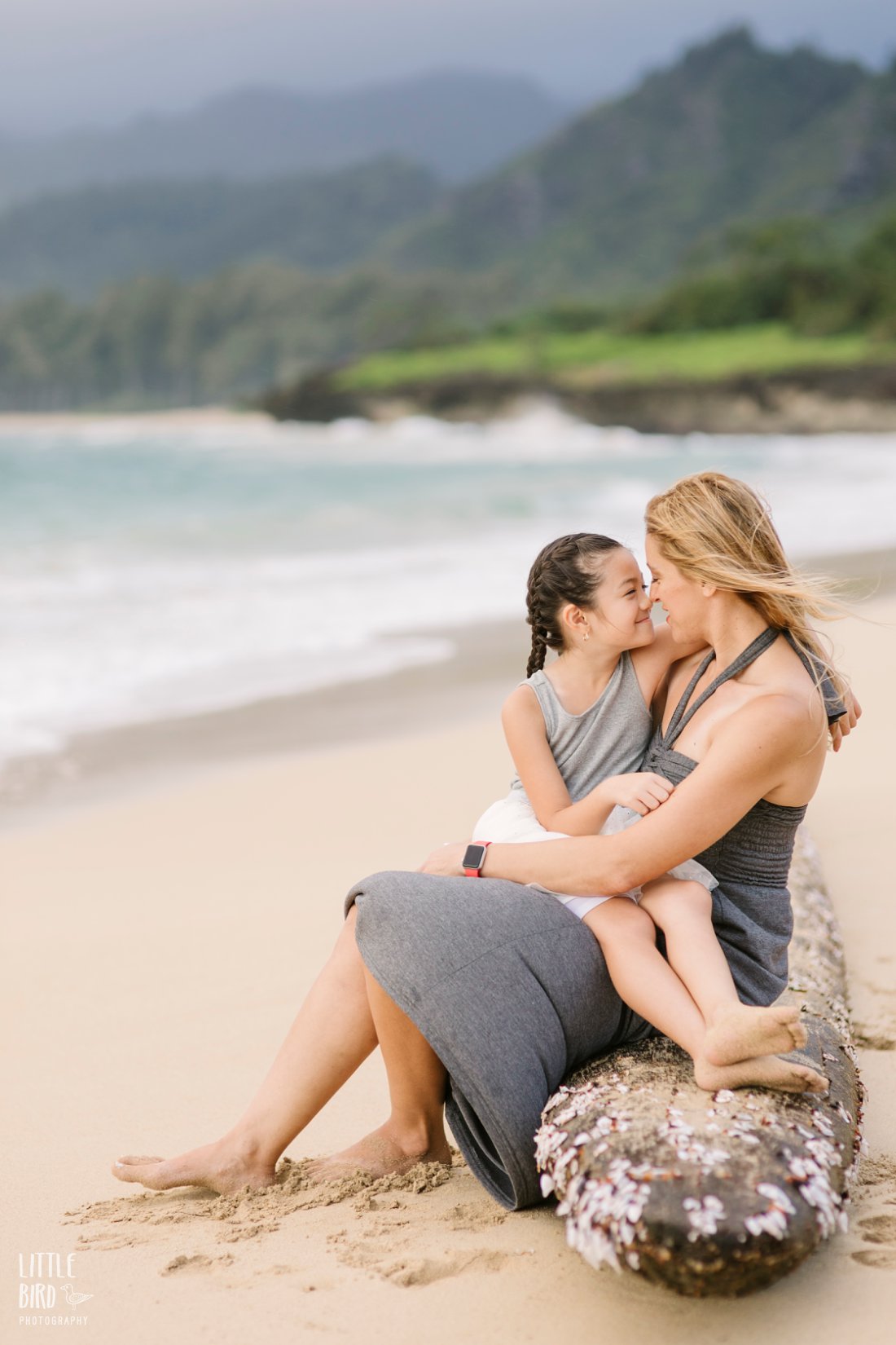 Mom and daughter share eskimo kisses during family beach pictures by Little Bird Photography