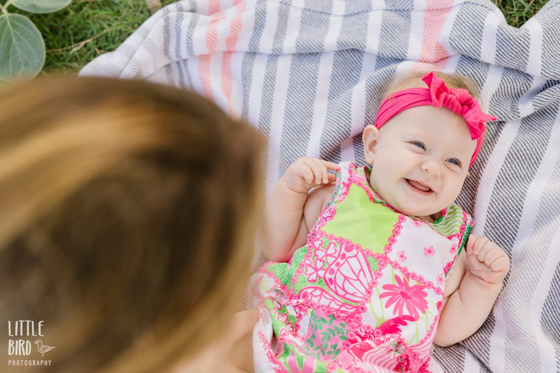 baby smiling on a blanket in hawaii beach park