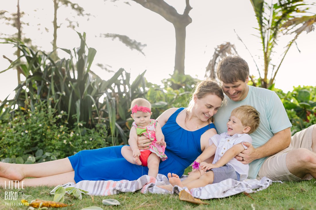 family snuggling at laie beach park during family photo session in oahu