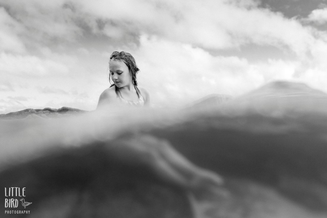 b&w portrait of a girl in the water half over half under