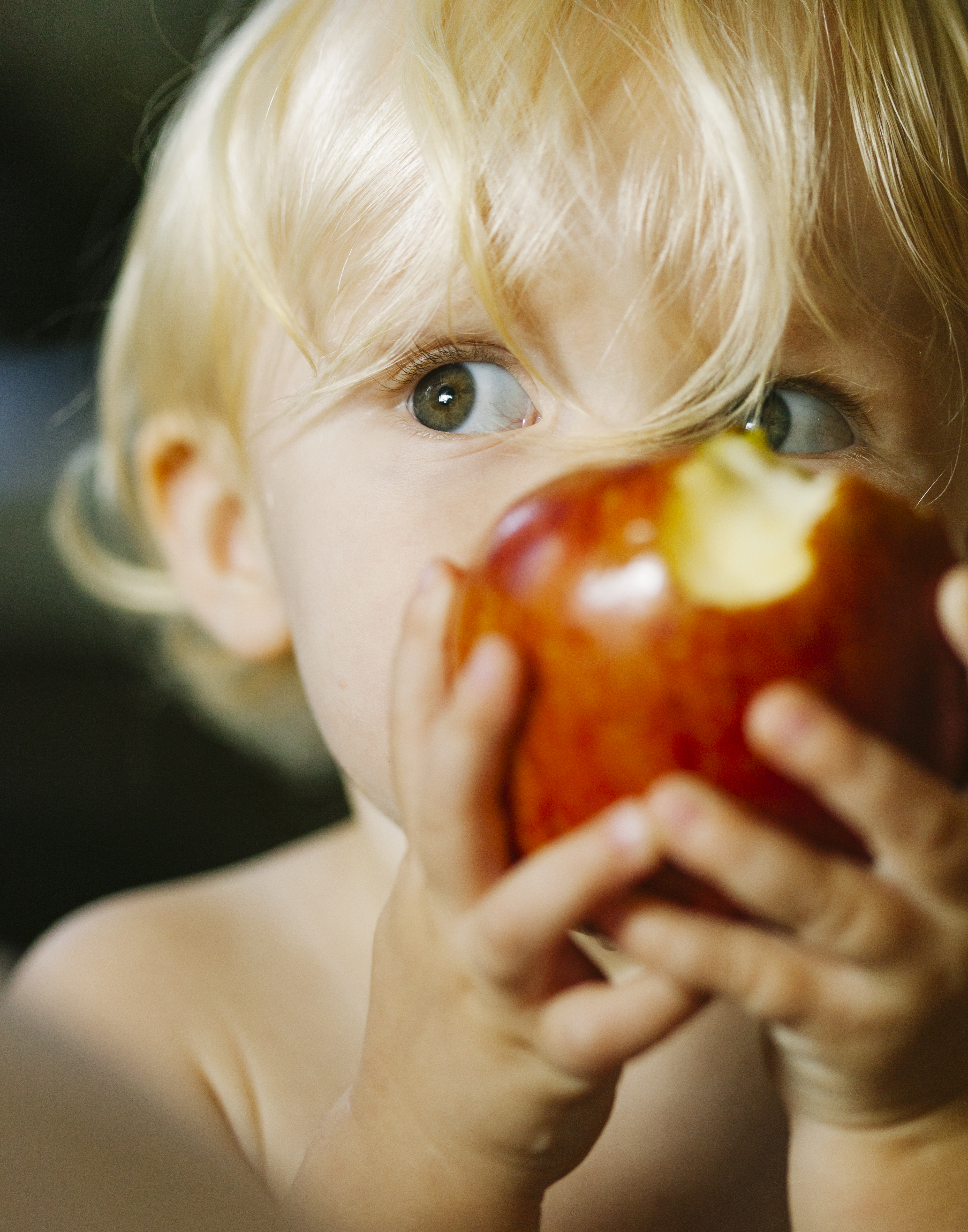 baby girl eating an apple