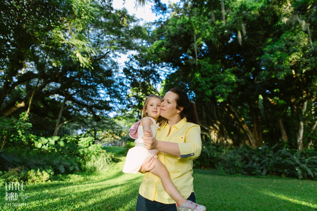 mom hugging daughter close during hawaii family photoshoot
