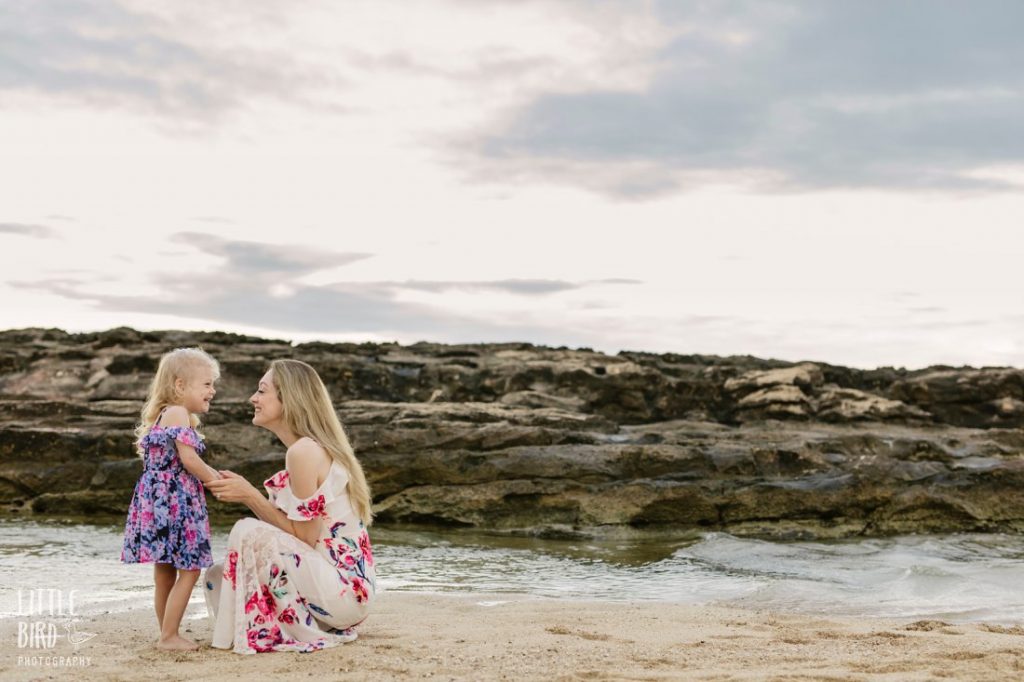 mom and daughter share a laugh during family photoshoot by little bird photography in hawaii