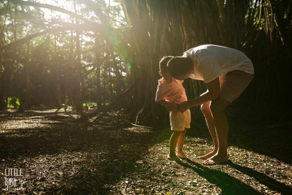 dad helping son during a jungle photo shoot in hawaii
