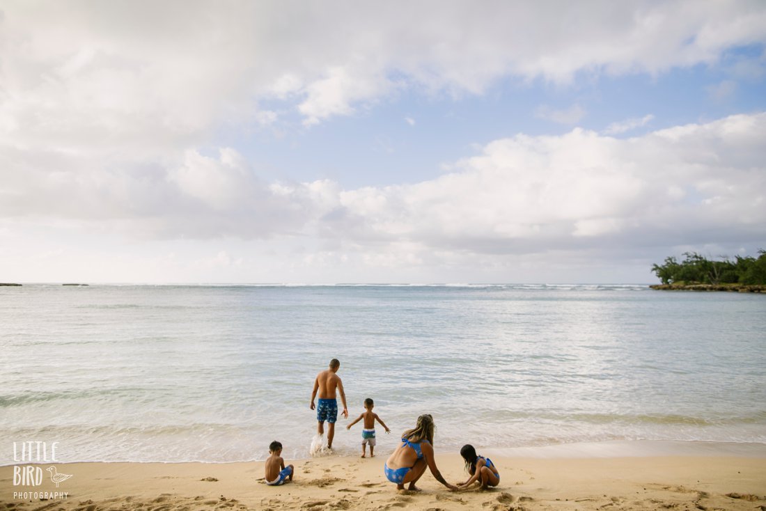 family wearing of one sea swimsuits during a photo shoot on the north shore of oahu