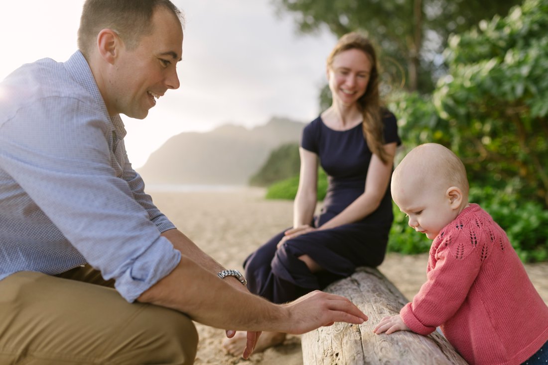 family playing at waimanalo beach park during a family photo session in hawaii