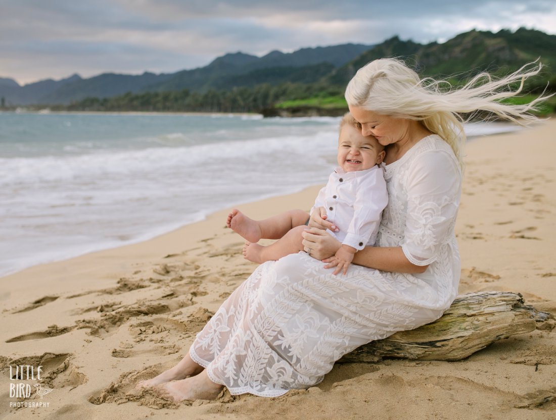 mom and baby boy cuddle during an oahu family photo session