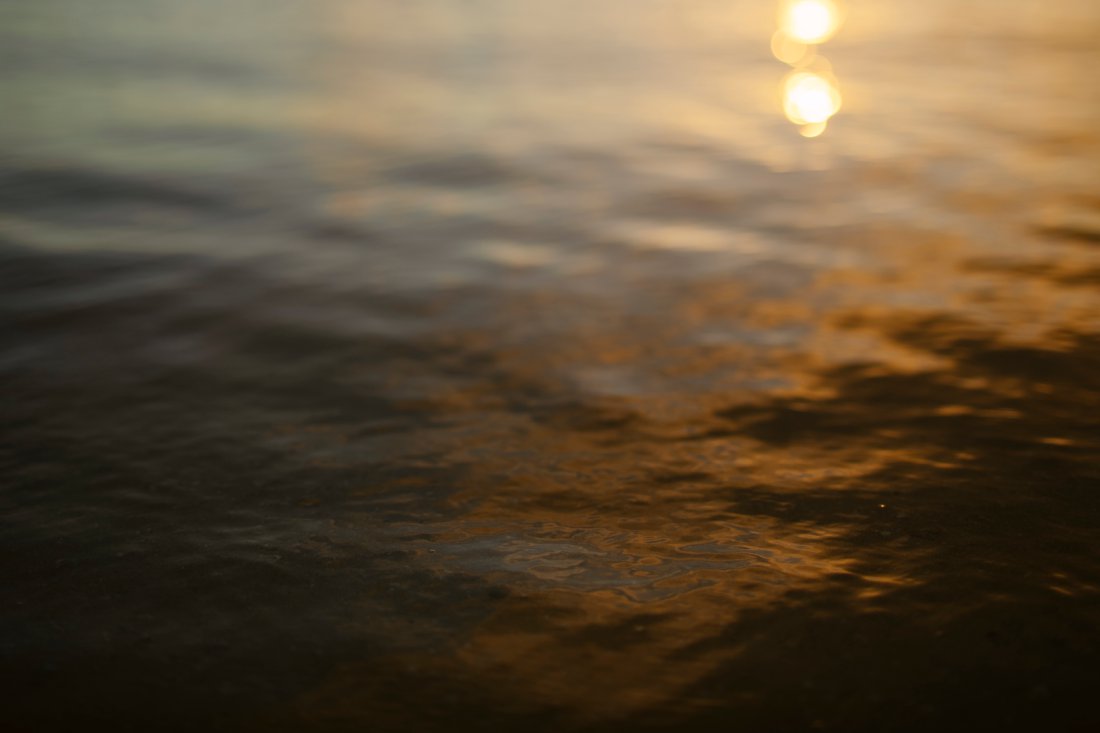 sunset on shimmering water at ala moana beach park