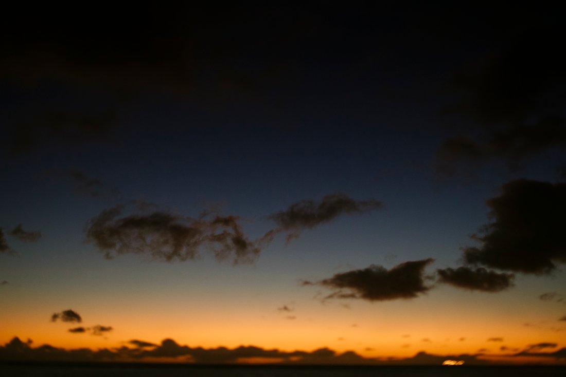 a brilliant blue and orange sunset in waikiki
