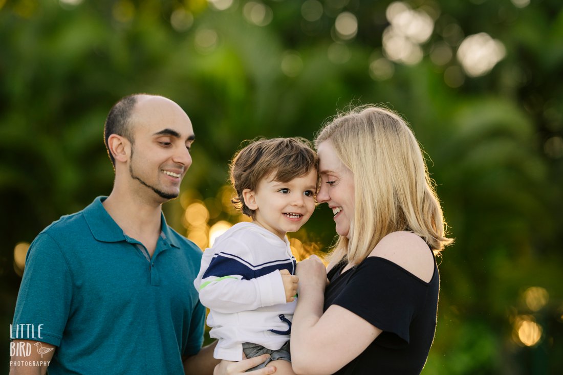 family of three playing during a fun family photo session