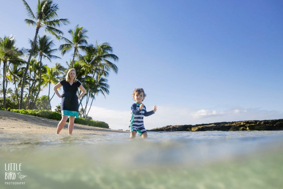 mom and son playing at the beach in koolina during a family photo shoot