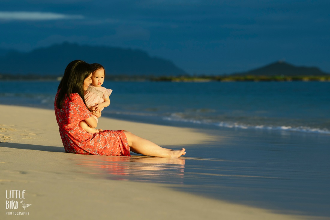 mom and baby sitting on the shore at lanikai beach for Hawaii Mini Portrait Session