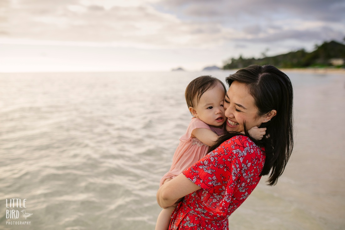 baby giving mom a big kiss at a beach in hawaii