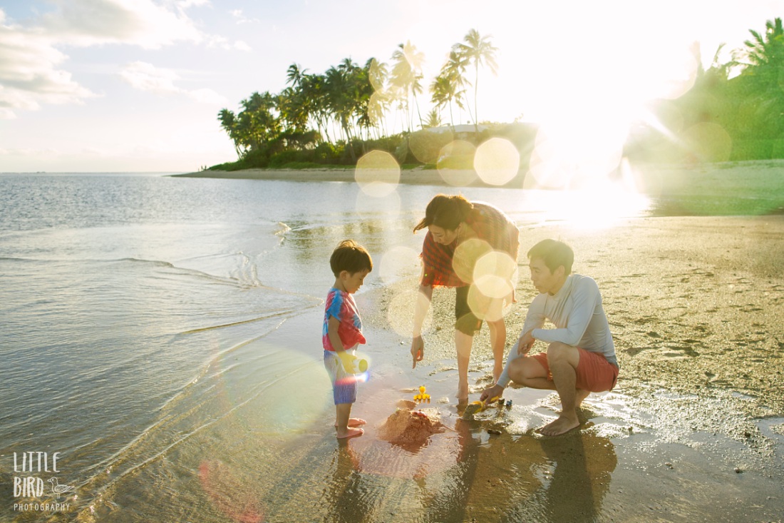 family playing in the sand during a photo session by little bird photography