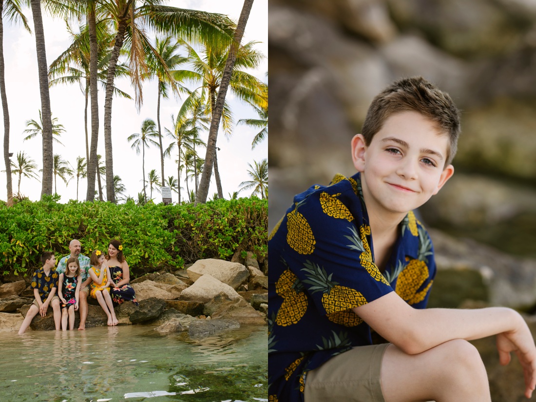 family lounging on rocks at the beach in koolina lagoons