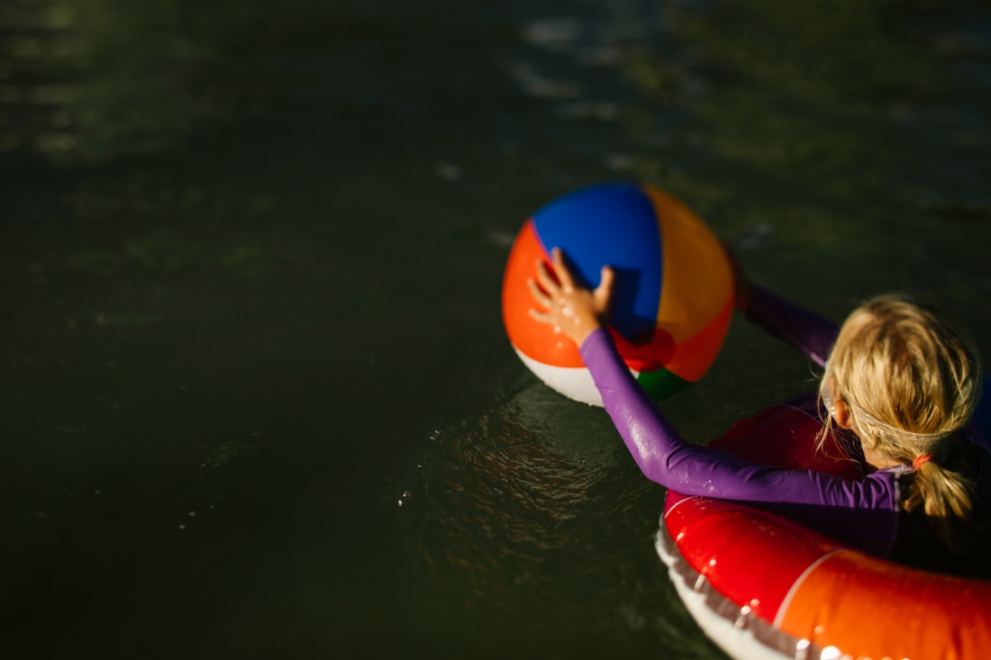 girl with a beach ball and float