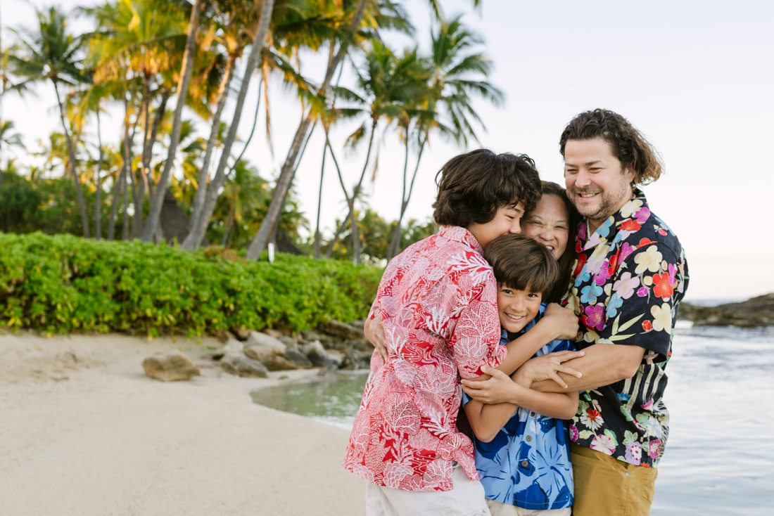 big family hug during a photo session in oahu hawaii