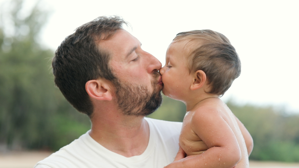 dad and baby kiss during a family photo session in hawaii