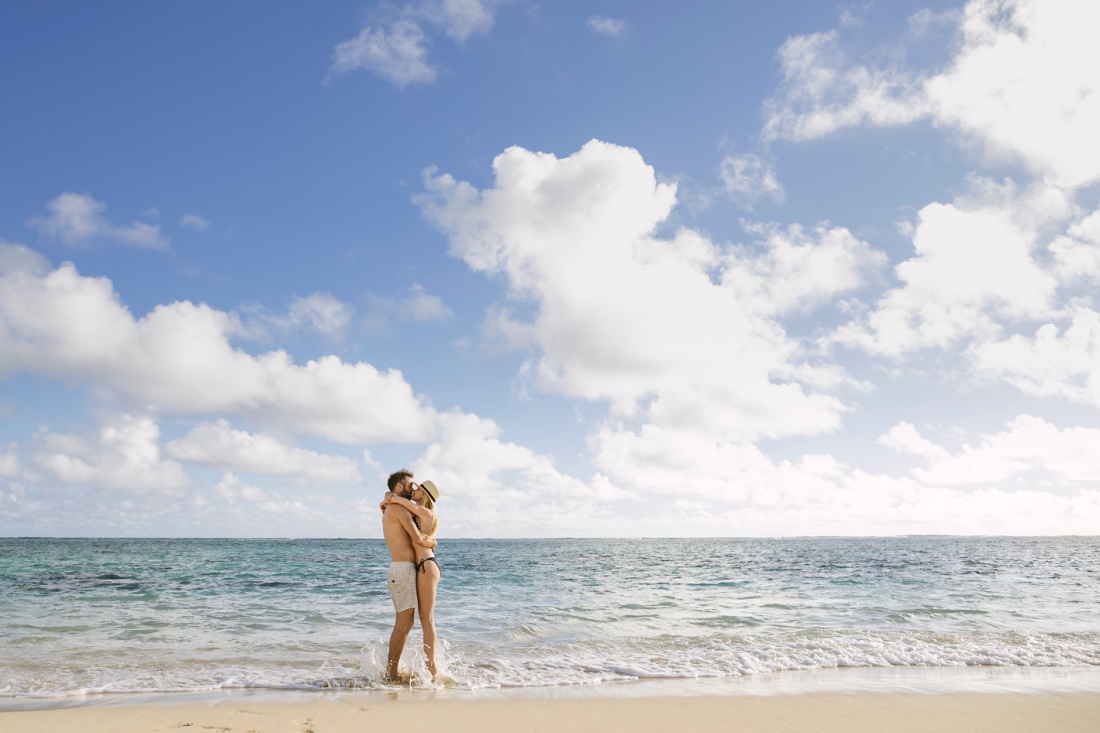 couple hugging at lanikai beach in hawaii