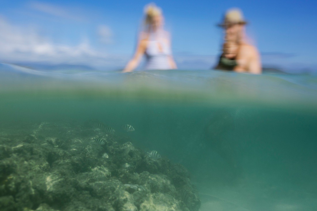 reef at lanikai beach with family in the background during a family portrait session