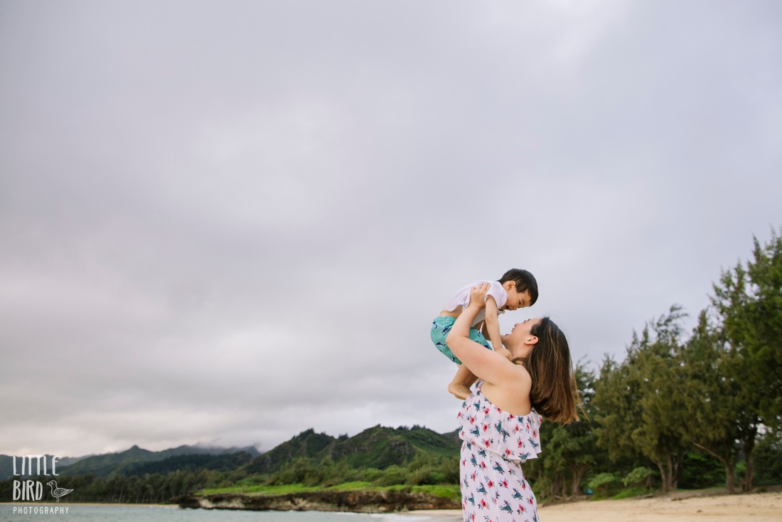 mom holding son in the air during Laie Portraits