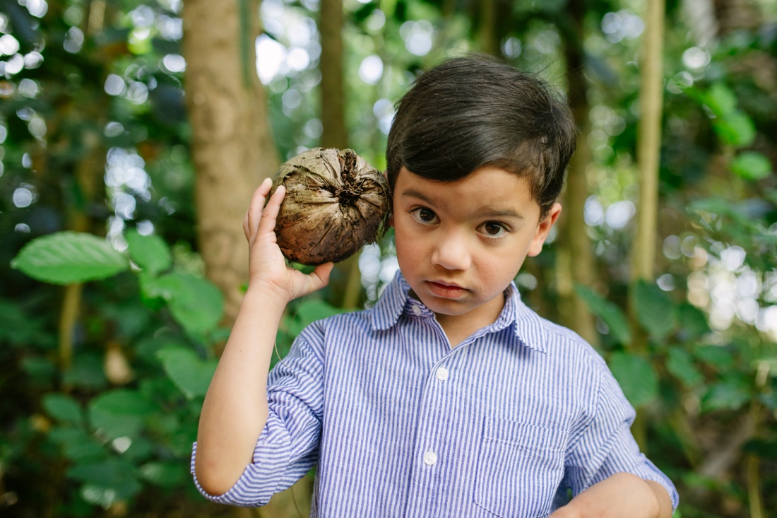 boy holding a coconut to his ear