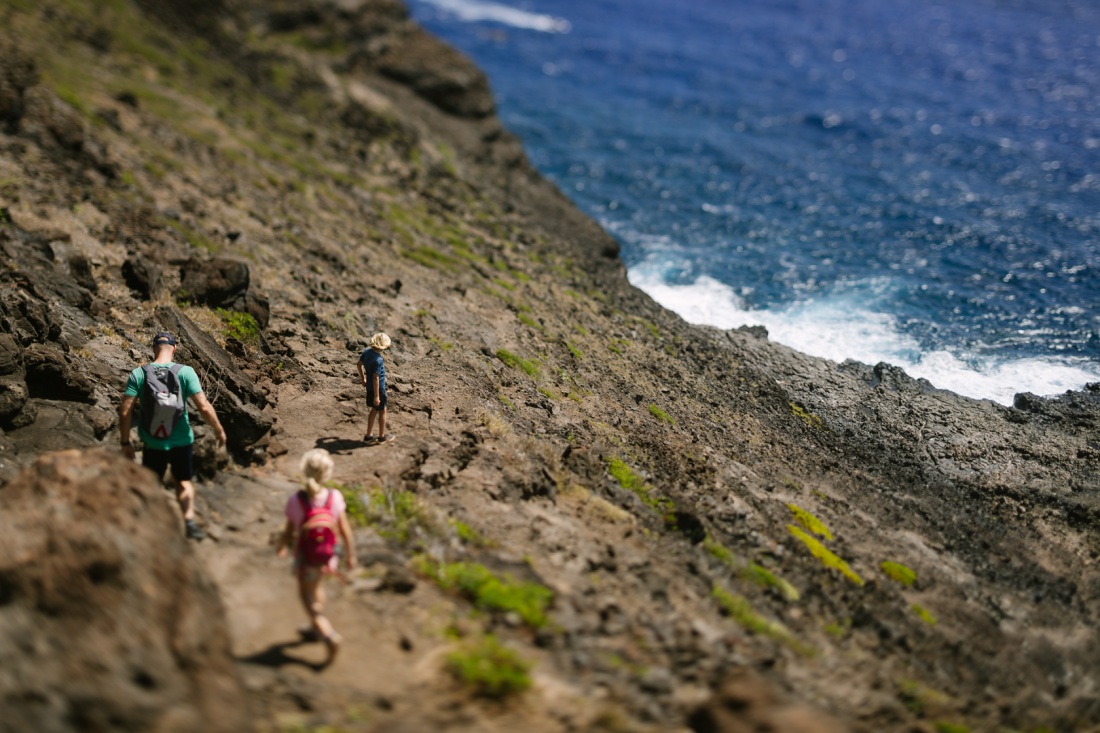 dad and kids hiking down the steep ascent to the makapuu tide pools on oahu