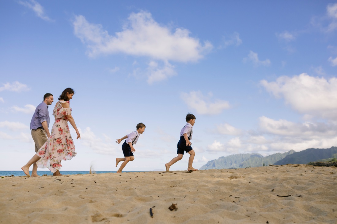 family running on the beach in hawaii