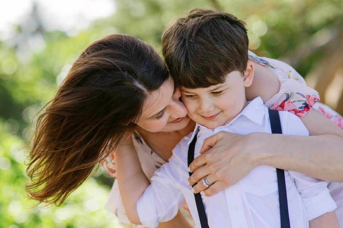 mom and son hugging during a fun family photoshoot in oahu