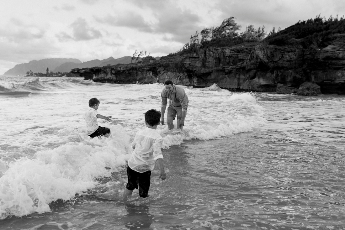 family playing in the surf in hawaii