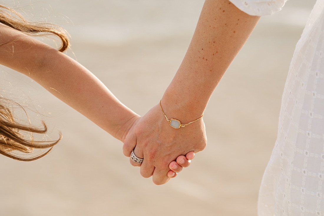 mom and daughter holding hands