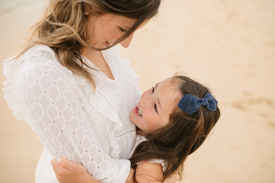 mom and daughter smiling 