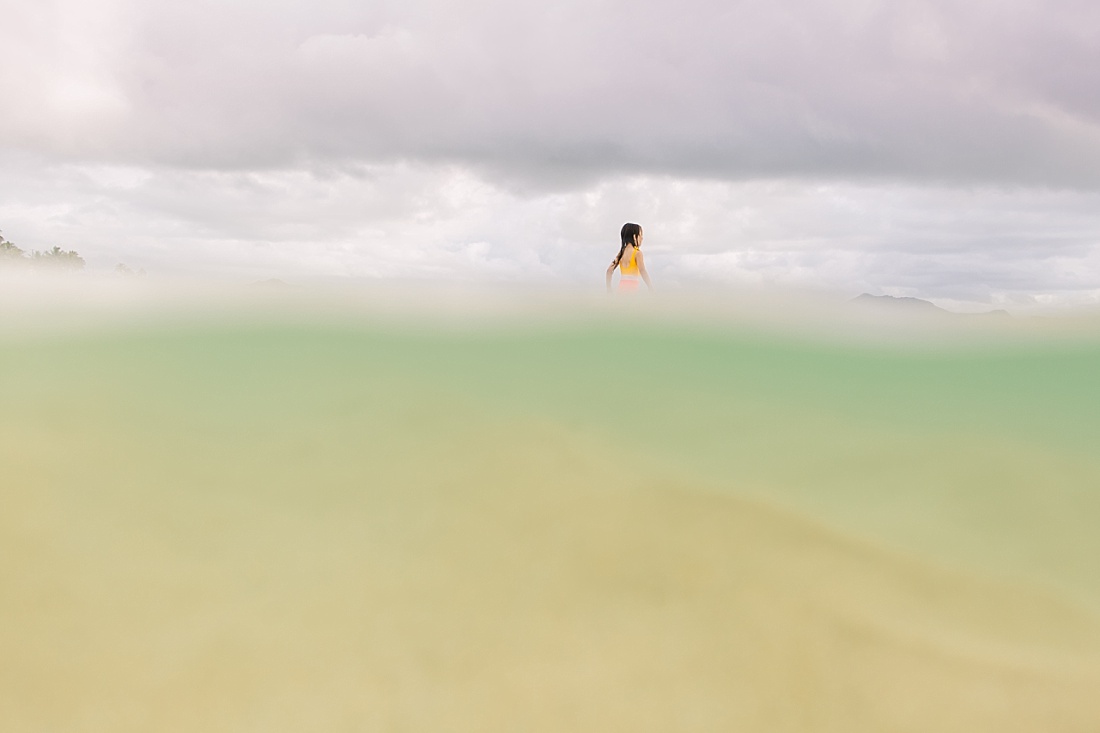 portrait of a girl from below the water at lanikai beach 