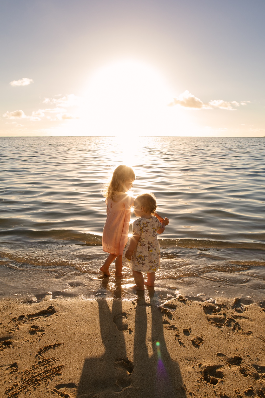 sisters dancing at lanikai beach during a sunrise family photo session