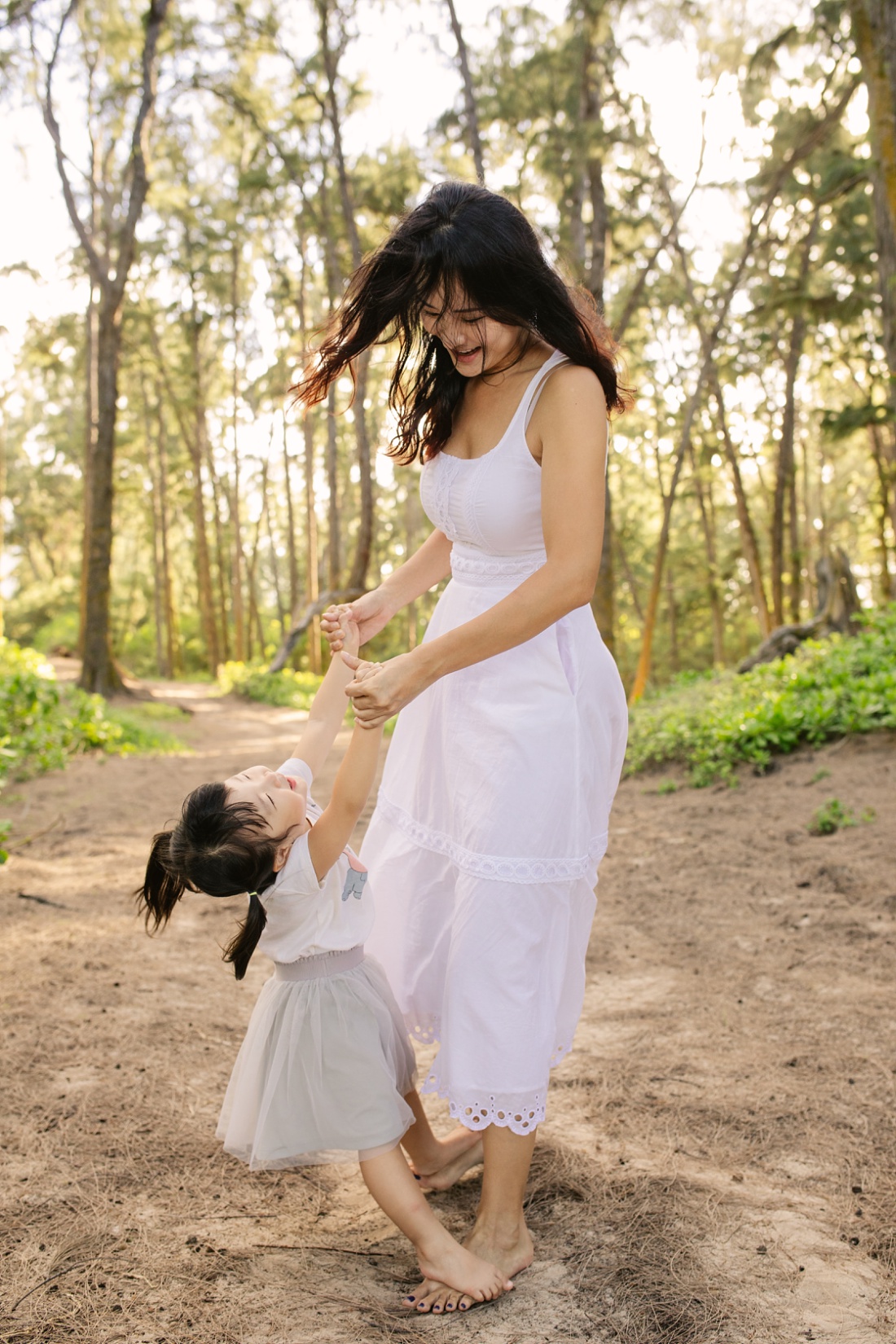 toddler daughter dances on moms feet during a family photo session at sherwoods by little bird photography