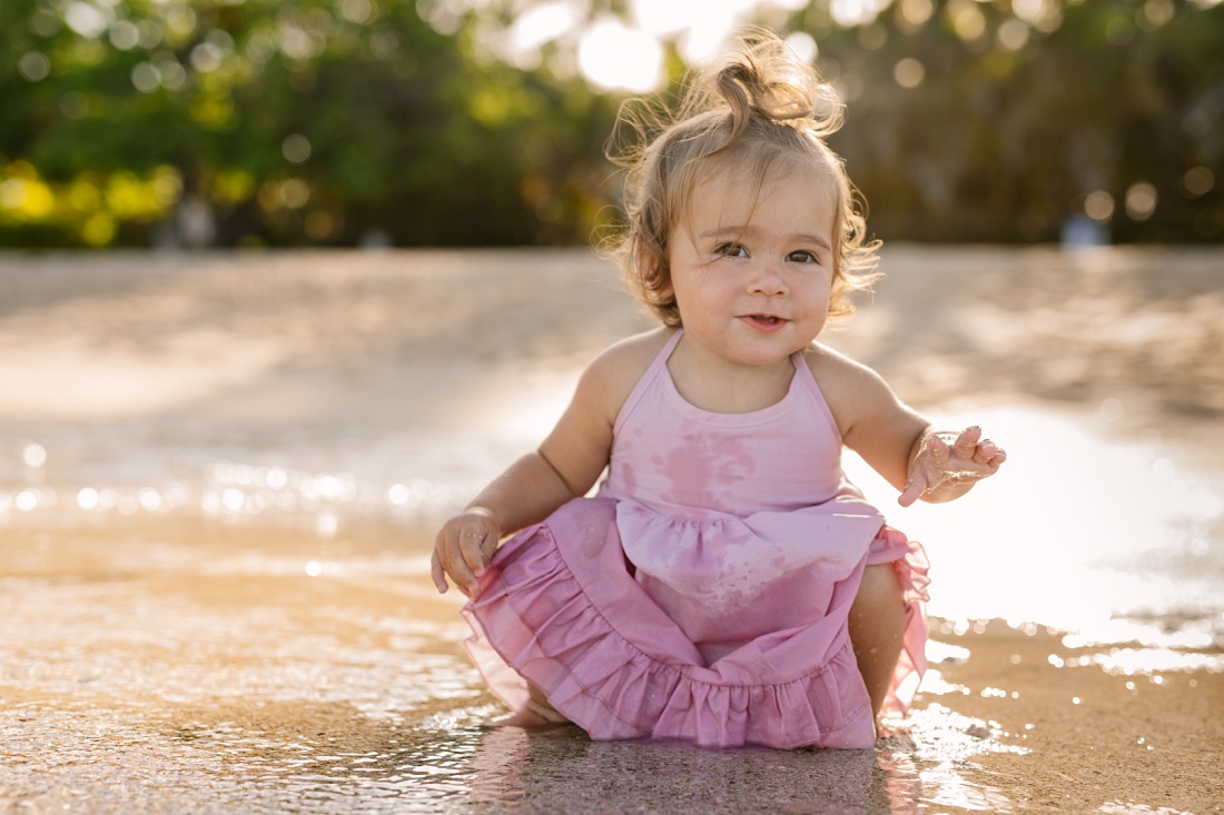 baby splashing in the shallows in hawaii by honolulu photographer