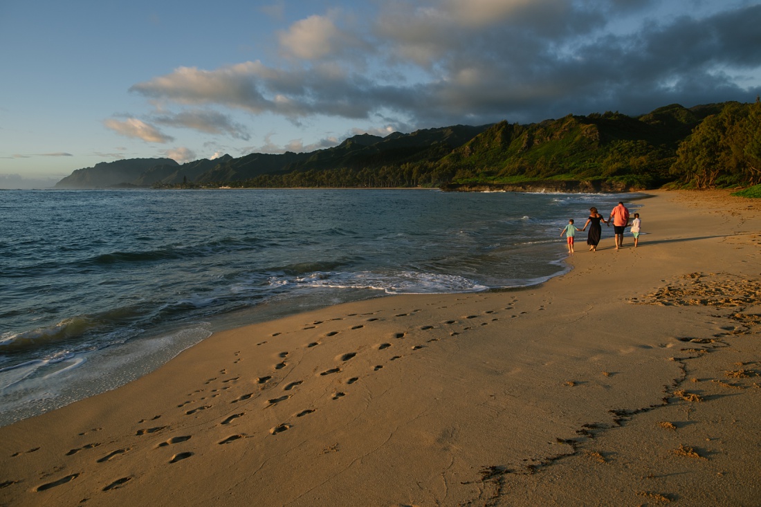 family walking at laie beach at sunrise