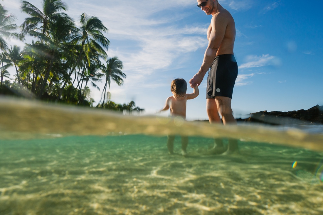 baby and dad in the clear waters of paradise cove ko olina