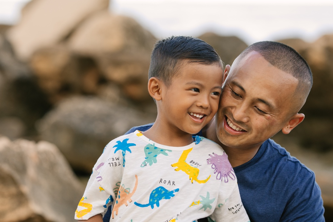 dad and son share a laugh during a family photo session by little bird photography + films