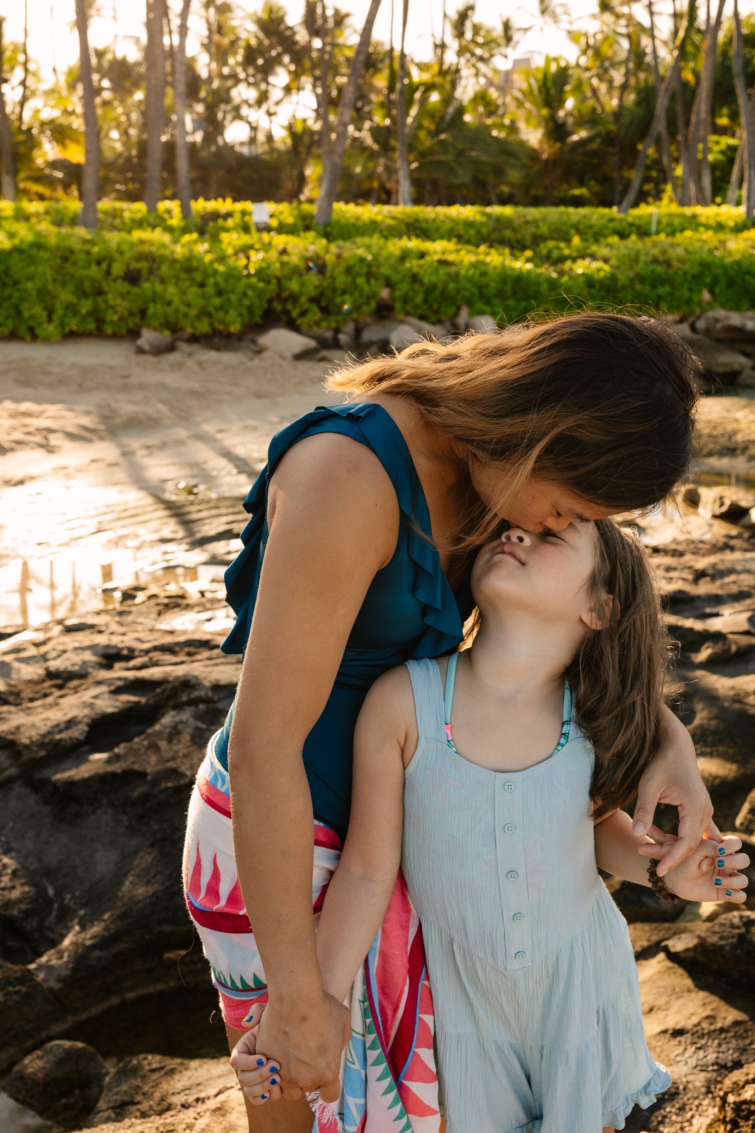 sweet portrait of mom and daughter at koolina beach in hawaii